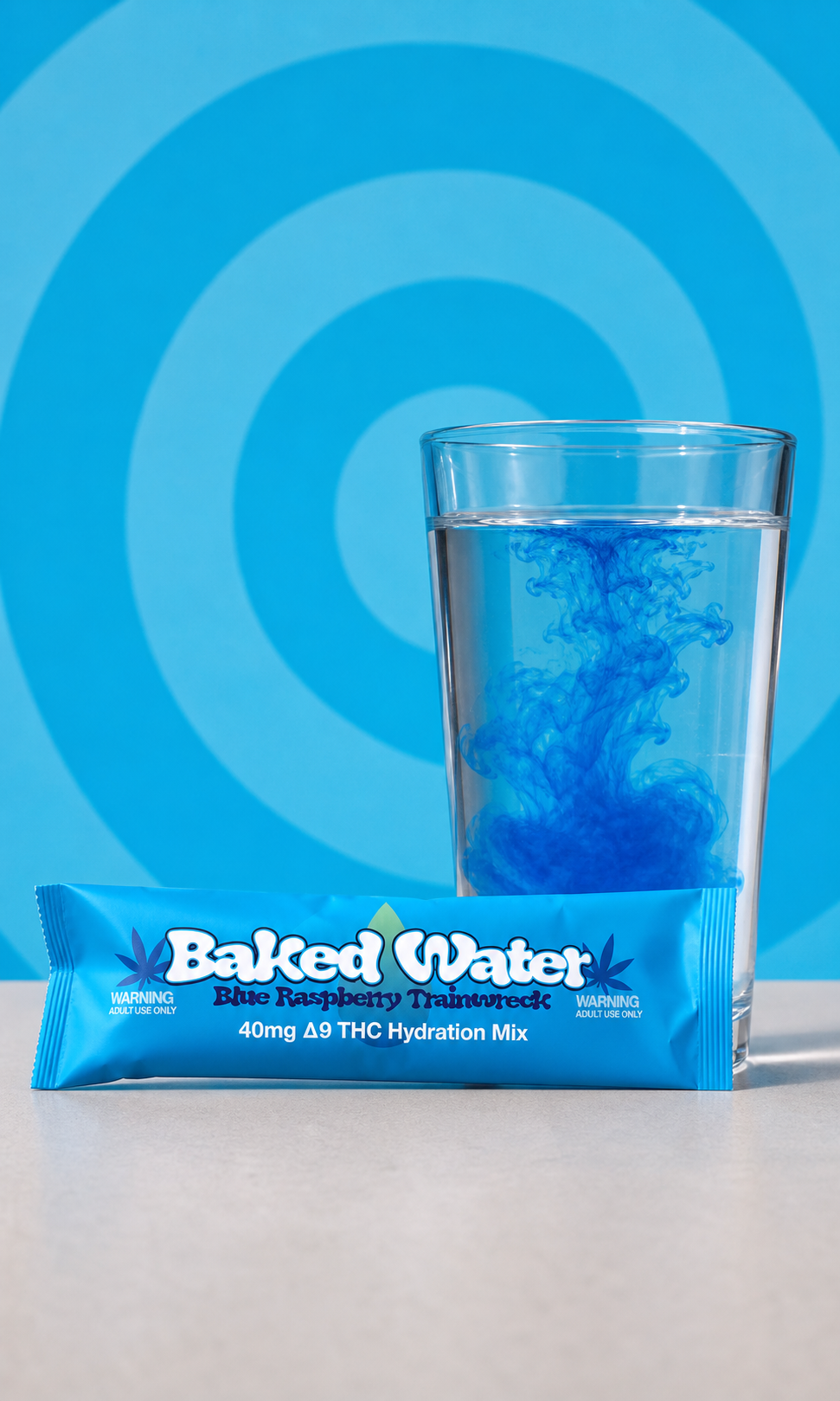 Baked Water Blue Raspberry Trainwreck packet beside a 12-ounce glass with blue drink mix swirling into the water